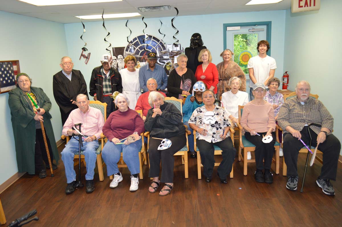 A large group of clients poses for a photo.