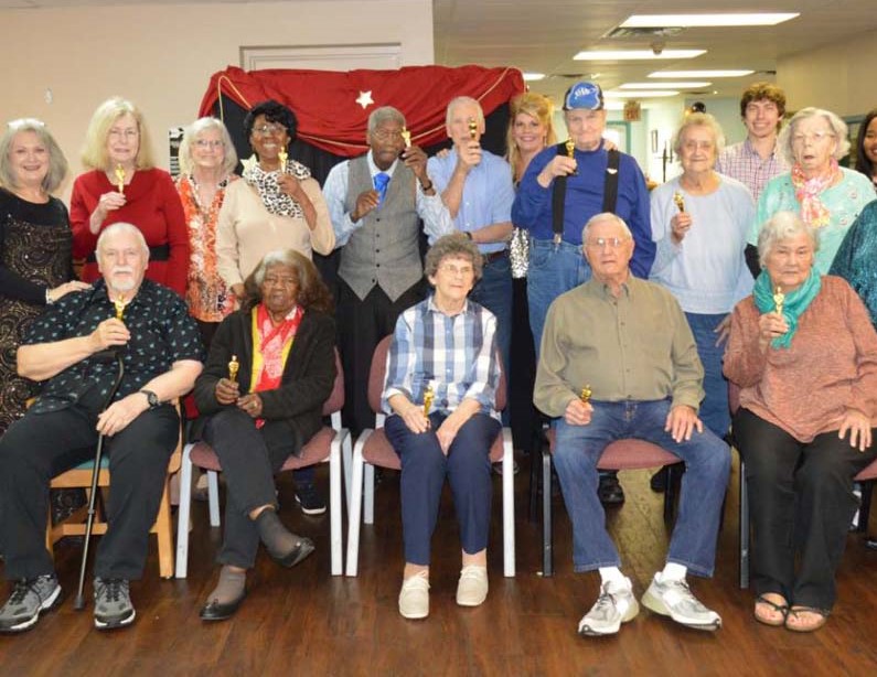 A group photo is taken during an Academy Awards party.